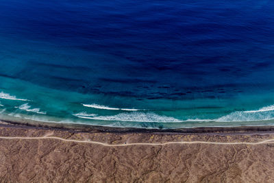 Scenic view of beach against blue sky