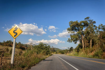 Road sign against sky