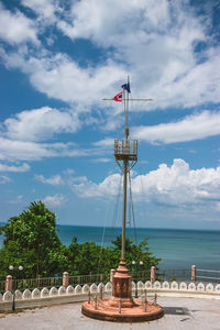 Lifeguard hut by sea against sky