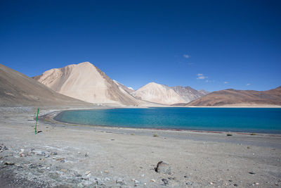 Scenic view of snowcapped mountains against blue sky