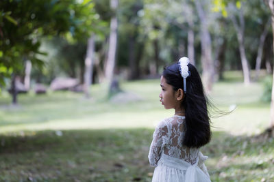 Side view of young woman standing on land