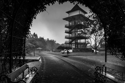 Road by building in city against sky