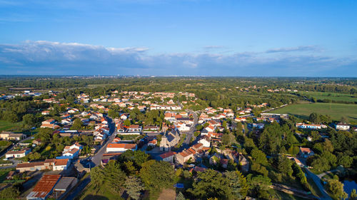 High angle view of houses in town against sky