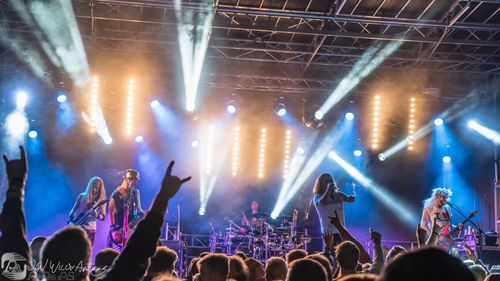 Rear view of people watching concert at night