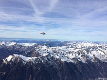 Helicopter flying above snowcapped mountains at chamonix