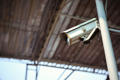 Low angle view of electric lamp hanging on ceiling