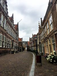 Street amidst buildings against sky