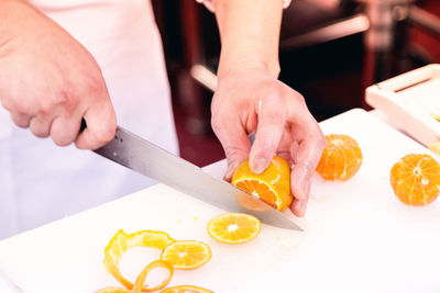 Midsection of man preparing food on cutting board