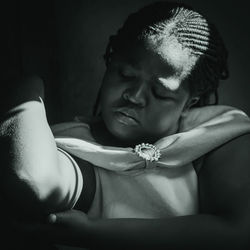 Close-up of young man sitting at darkroom