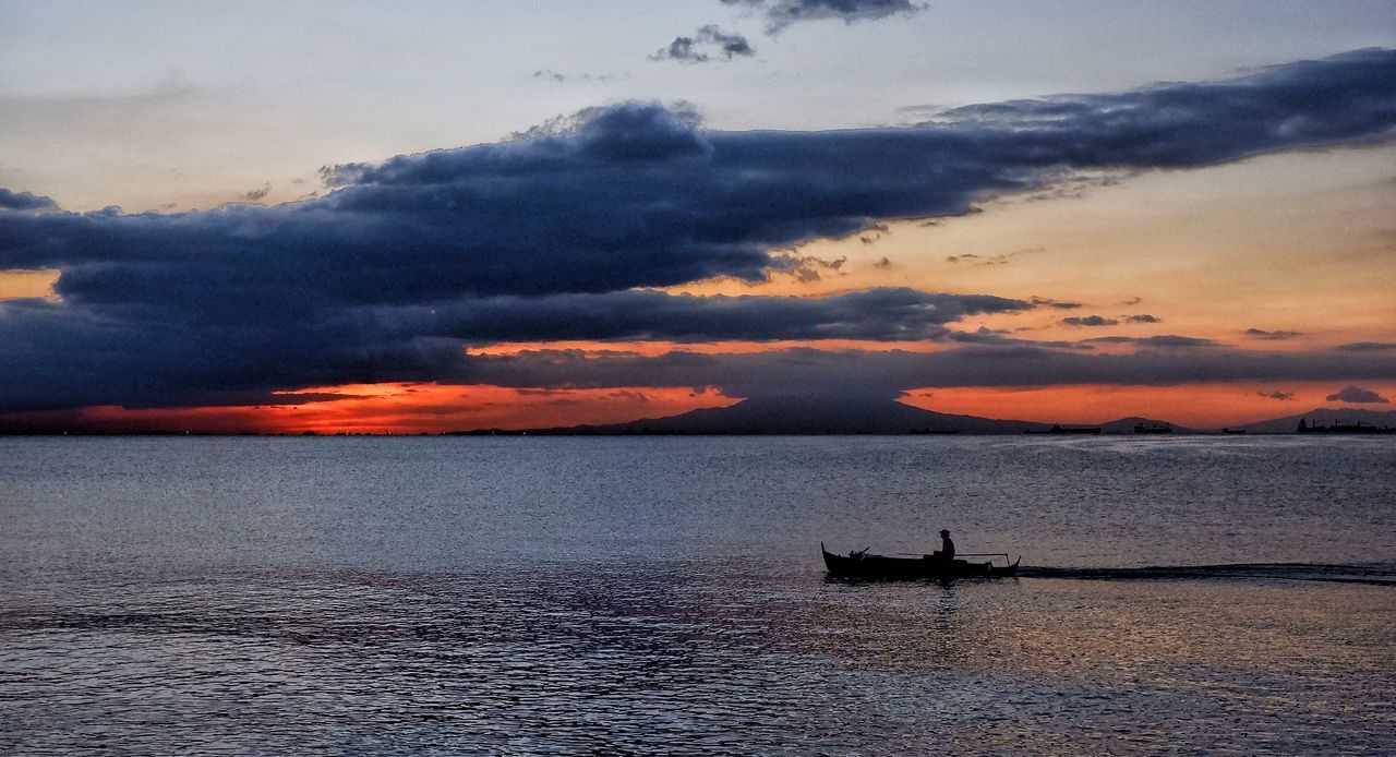 SCENIC VIEW OF SEA AGAINST ORANGE SKY