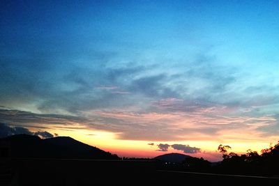 Scenic view of silhouette landscape against romantic sky at sunset