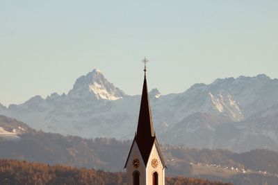 Low angle view of building and mountains against sky