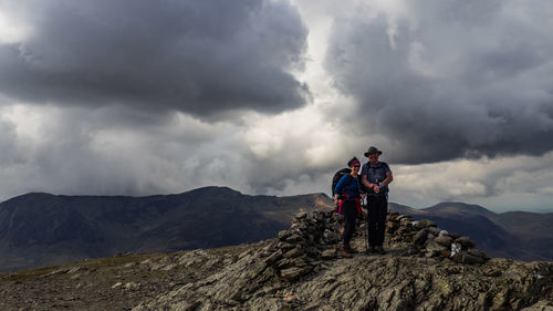 People on mountain against sky