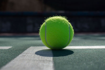 Close-up of tennis ball in court