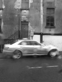 Car on street against buildings in city