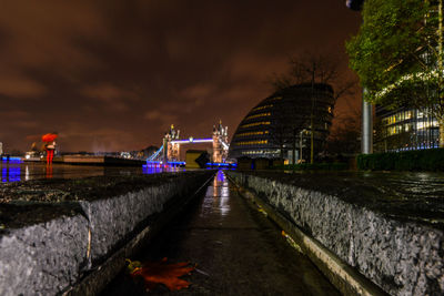 Illuminated walkway at night