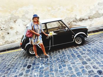 Full length of boy standing in car