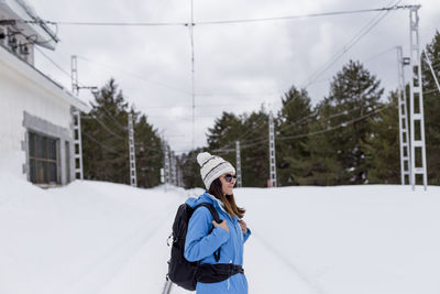 Woman standing on snow covered trees