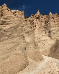 Low angle view of rock formation in desert against sky