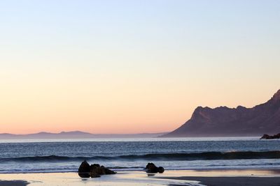 Scenic view of sea against clear sky during sunset