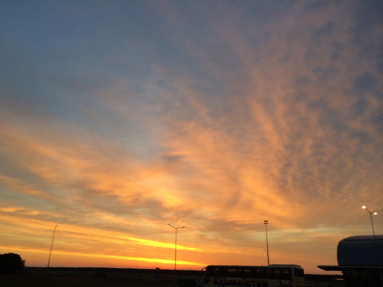 sunset, sky, orange color, scenics, beauty in nature, tranquility, silhouette, tranquil scene, cloud - sky, sea, nature, idyllic, dramatic sky, street light, cloud, transportation, moody sky, outdoors, cloudy, sun