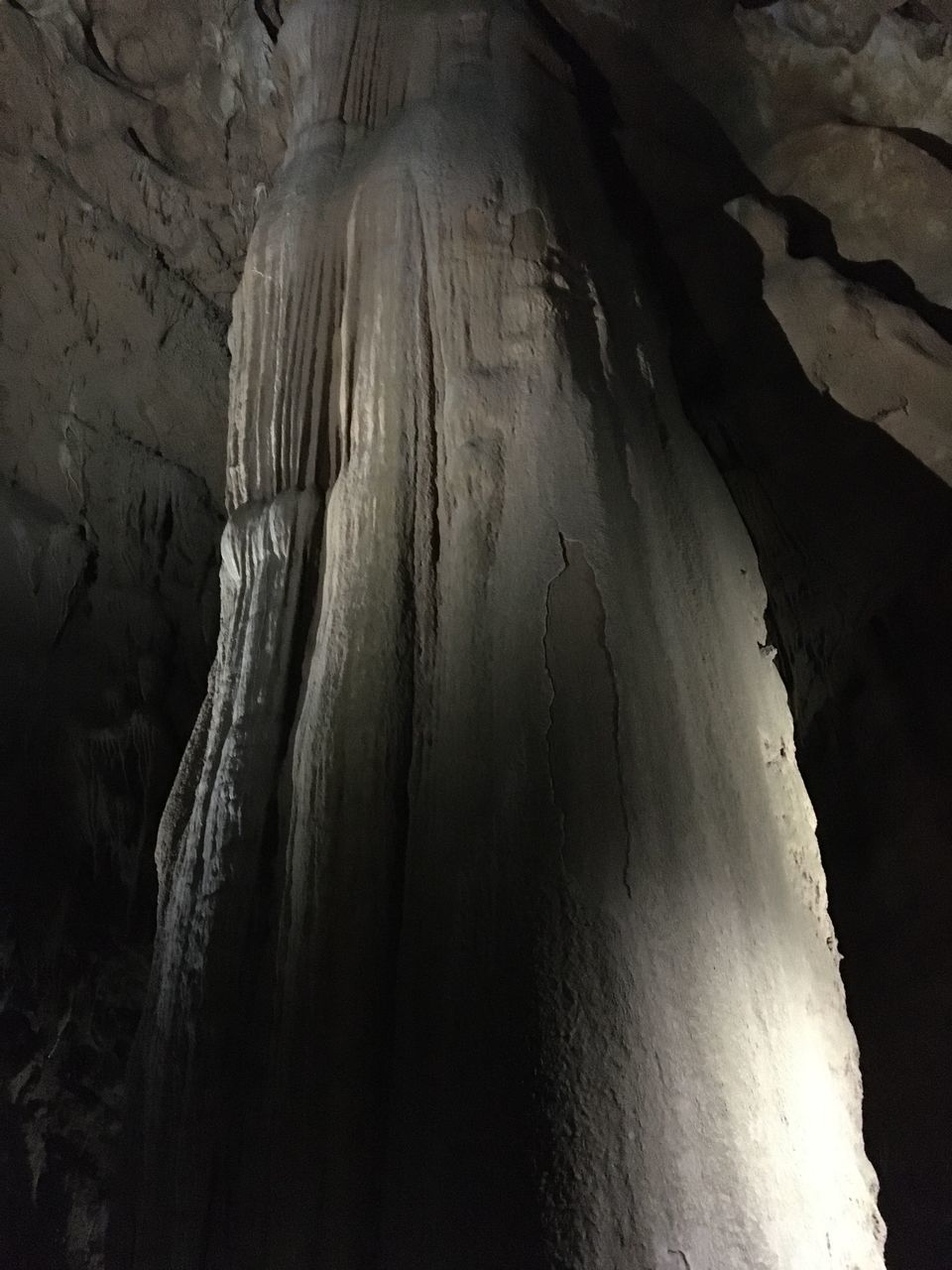 LOW ANGLE VIEW OF ICICLES ON ROCK FORMATION