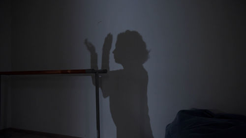 Shadow of woman on wall in darkroom