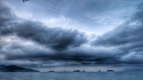 Scenic view of sea against storm clouds