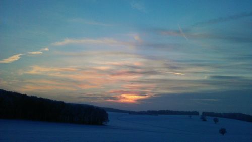 Scenic view of landscape against sky at sunset