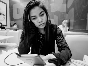 Portrait of young woman sitting outdoors