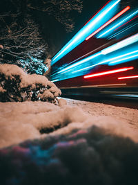 Low angle view of light trails at night