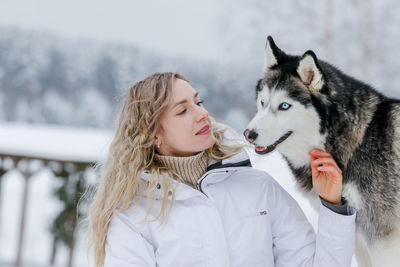 Young woman with dog in snow