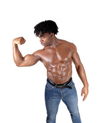 Full length of shirtless man standing against white background