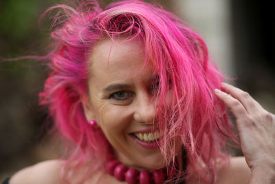 Portrait of beautiful young woman with pink hair