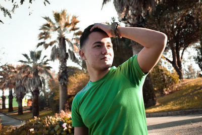 Portrait of young man looking away outdoors