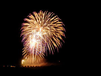 Low angle view of firework display at night