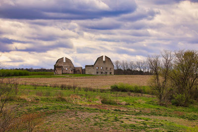 Built structure on field against sky