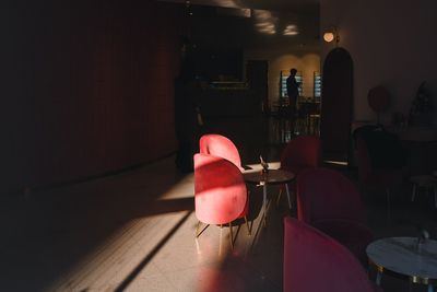 Tables and chairs in dark restaurant