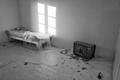 Abandoned bed and television set in room