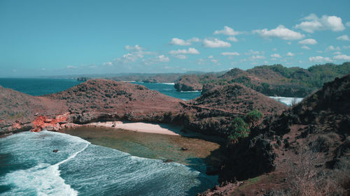 Scenic view of sea and mountains against sky