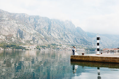 Scenic view of lake and mountains against sky