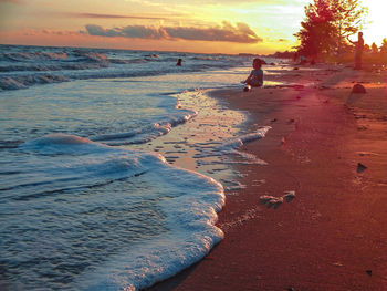 Scenic view of beach against sky during sunset