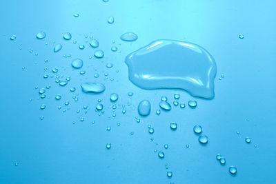 Close-up of water drops on blue surface