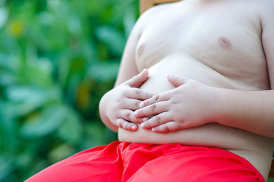 Close-up of woman with red hands