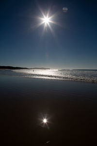 Scenic view of sea against sky on sunny day