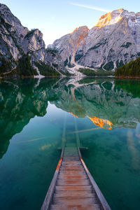 Scenic view of lake by mountains against sky