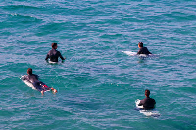 High angle view of people swimming in sea