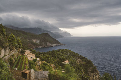 Scenic view of sea and mountains against sky