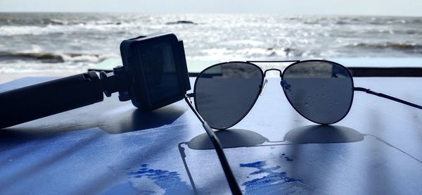 Close-up of sunglasses on beach