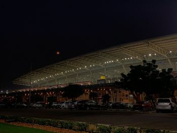 Illuminated city against clear sky at night